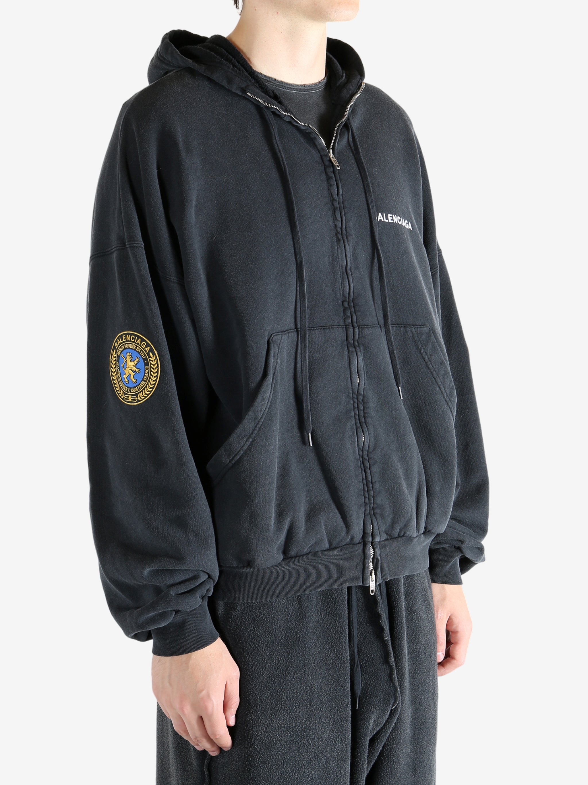 Black hoodie worn by a person, showing the hoodie's fit