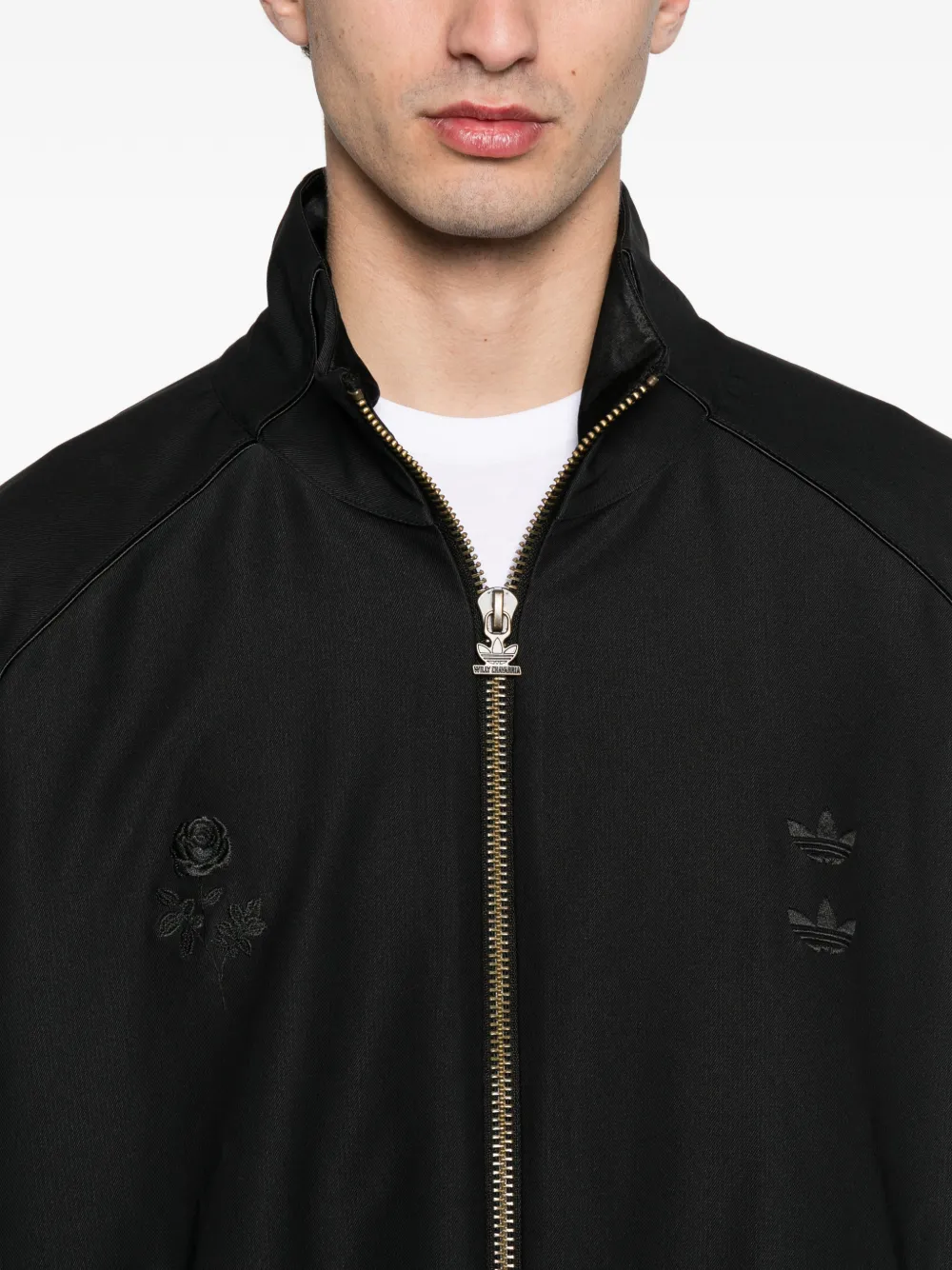 Close up of black jackets, showing texture of the recycled polyester and elastane fabric