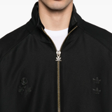 Close up of black jackets, showing texture of the recycled polyester and elastane fabric