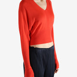 Red long-sleeve top worn by a person, showing the top fit