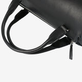 Close up of black bag, showing texture of the leather fabric