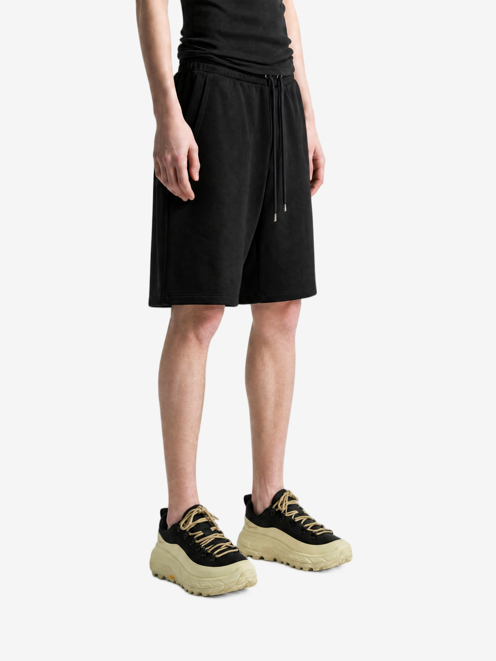 Black shorts worn by a person, showing the shorts fit