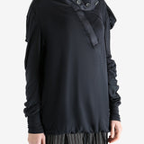 Black top worn by a person, showing the top's fit