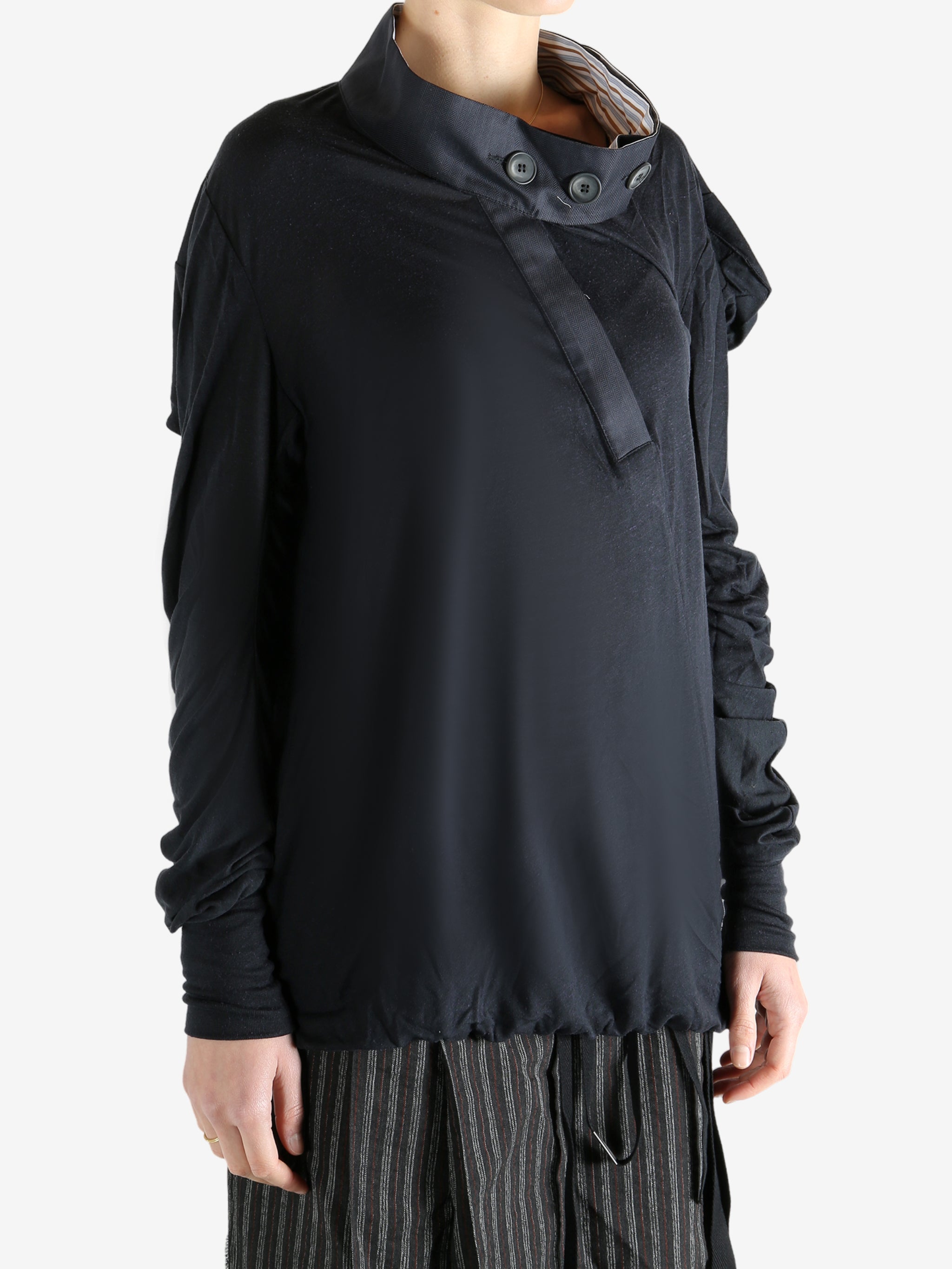 Black top worn by a person, showing the top's fit