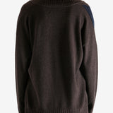 Brown sweater worn by a person, showing the sweater's fit