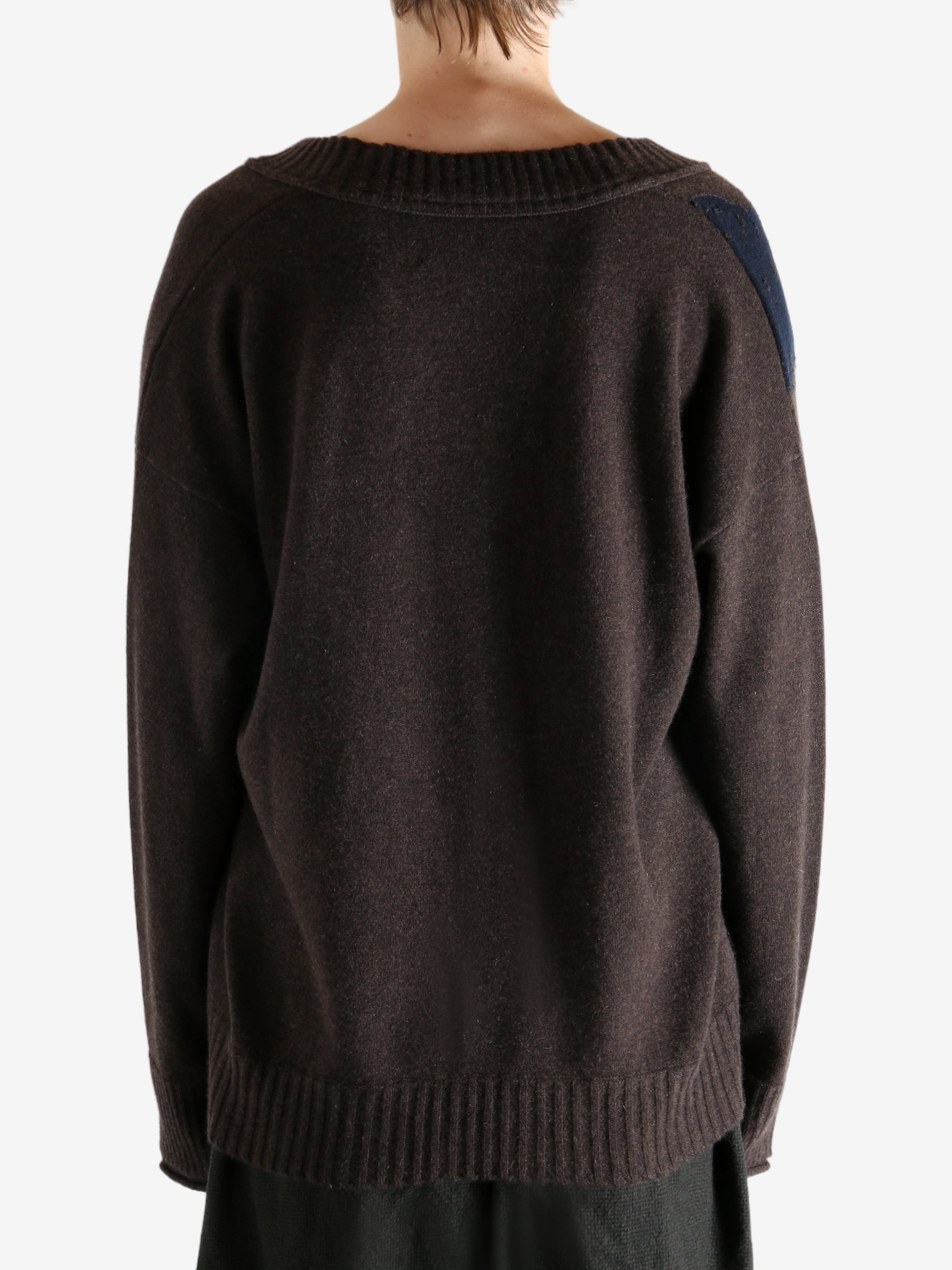 Brown sweater worn by a person, showing the sweater's fit