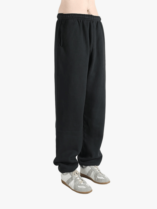 Black sweatpants worn by a person, showing the sweatpants fit