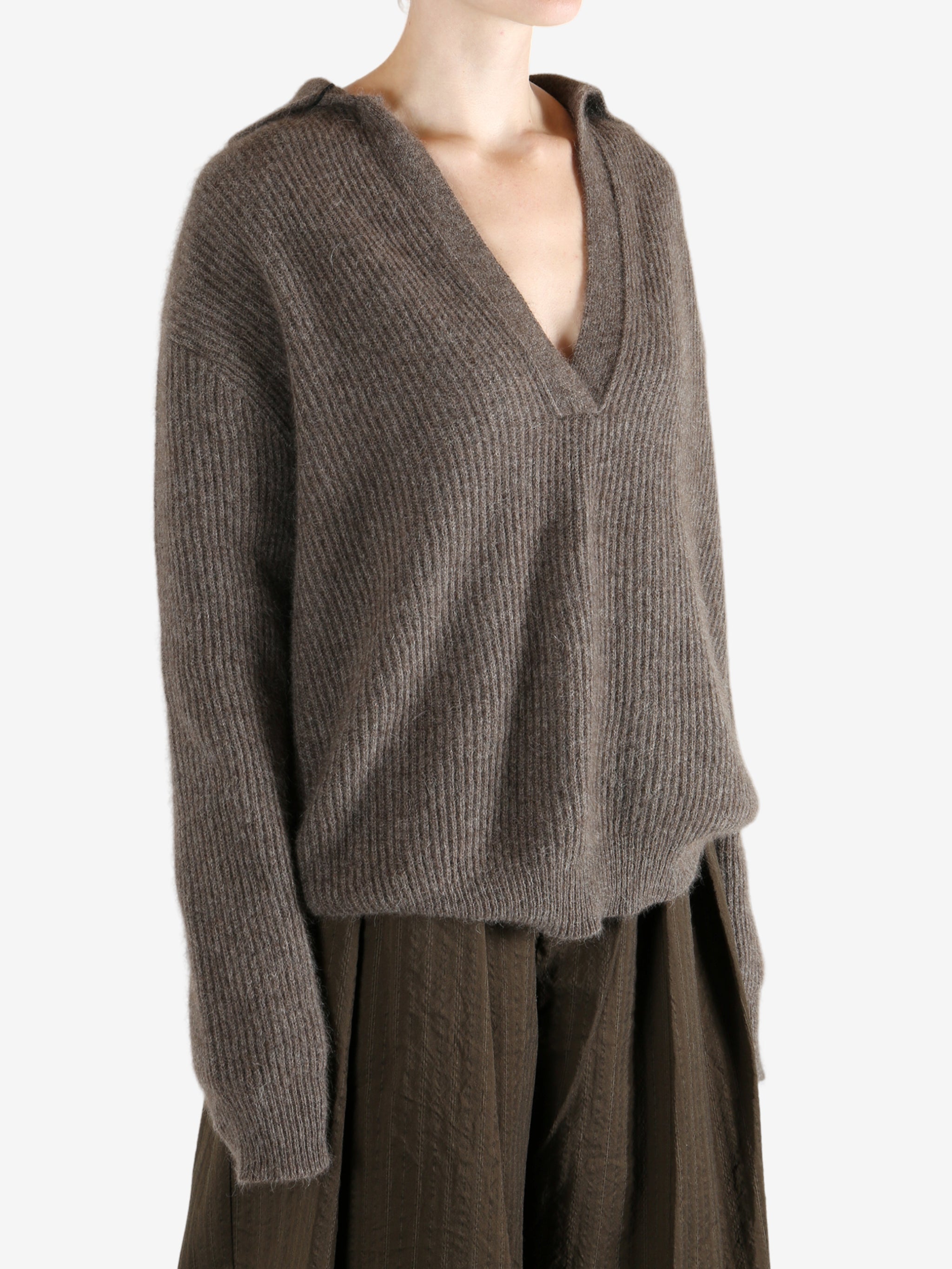 Brown sweater worn by a person, showing the sweater's fit