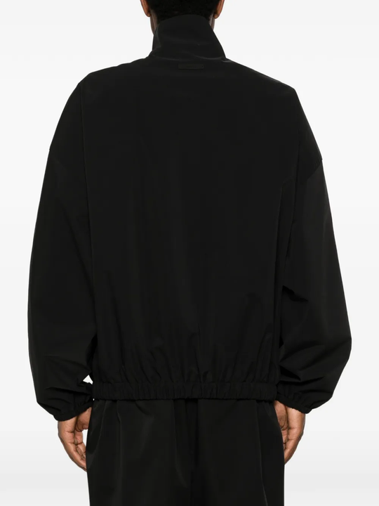 Black coats worn by a person, showing the coats fit