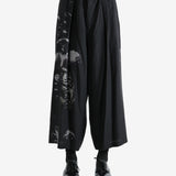 Black pants worn by a person, showing the pants fit