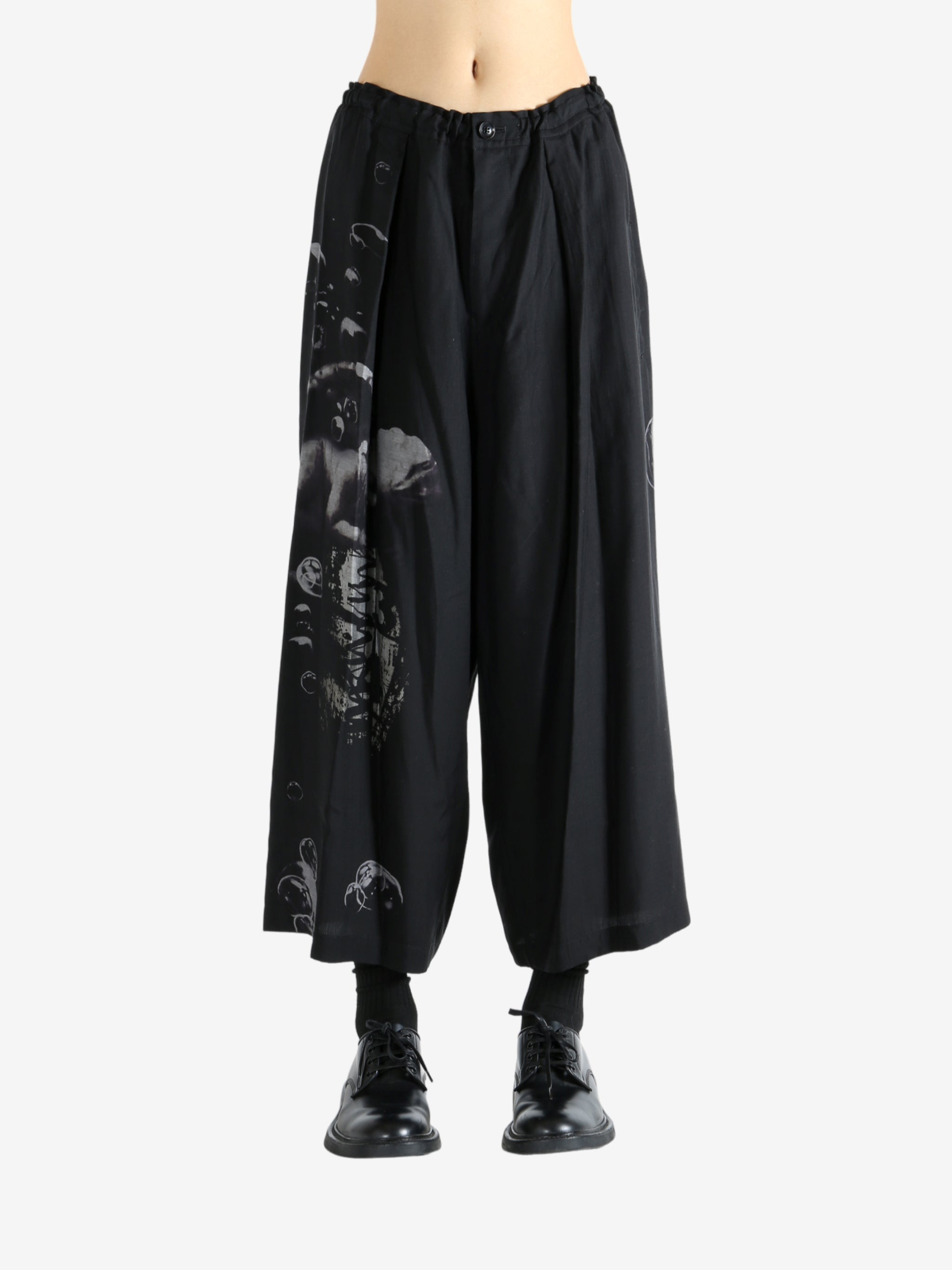 Black pants worn by a person, showing the pants fit