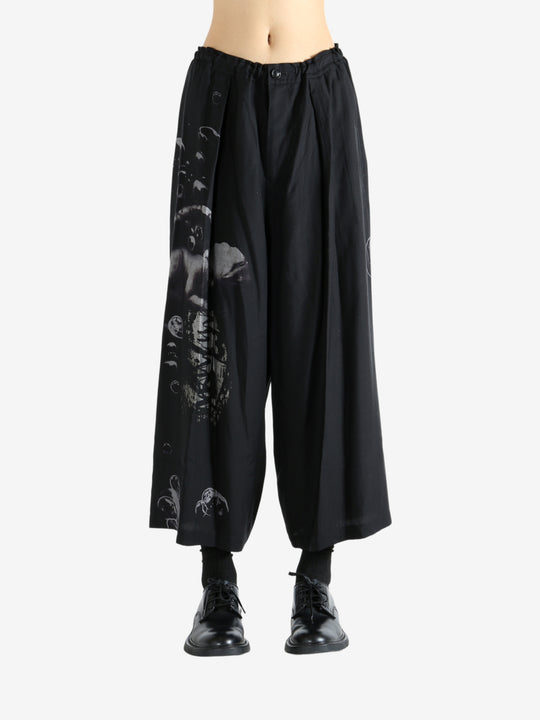 Black pants worn by a person, showing the pants fit