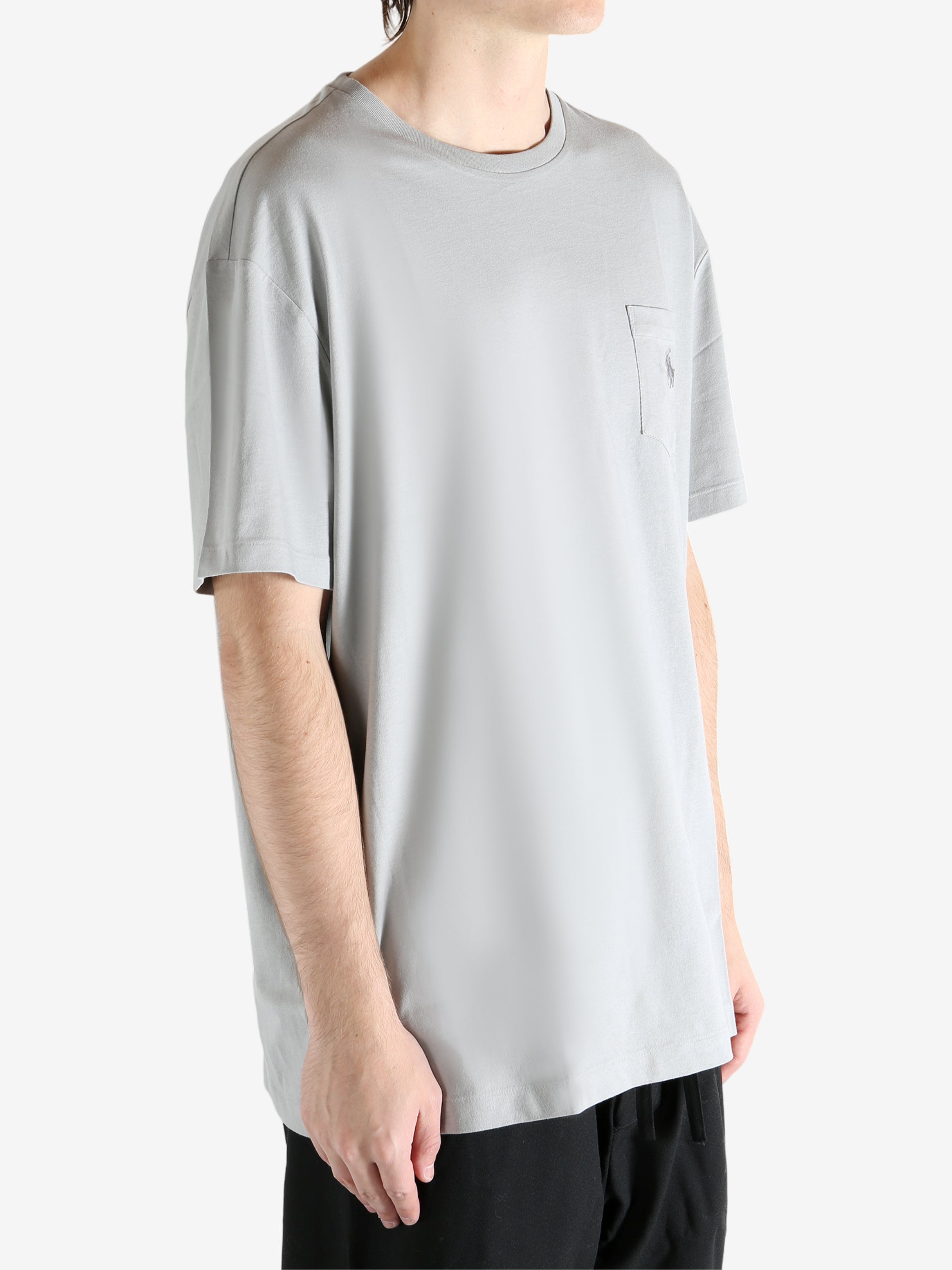 Grey t-shirts worn by a person, showing the t-shirts fit