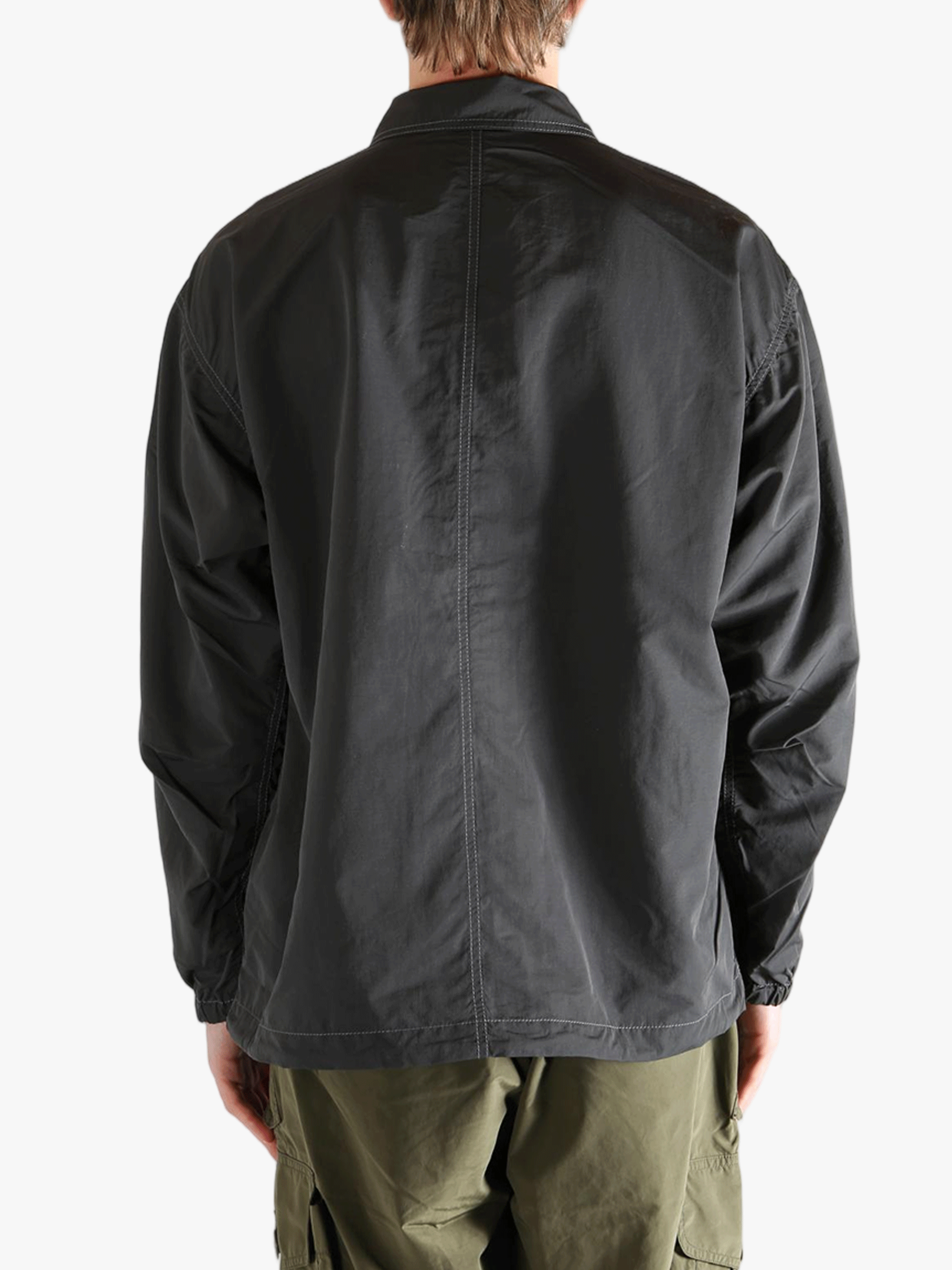 Black jacket worn by a person, showing the  jacket's fit