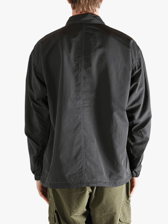 Black jacket worn by a person, showing the  jacket's fit