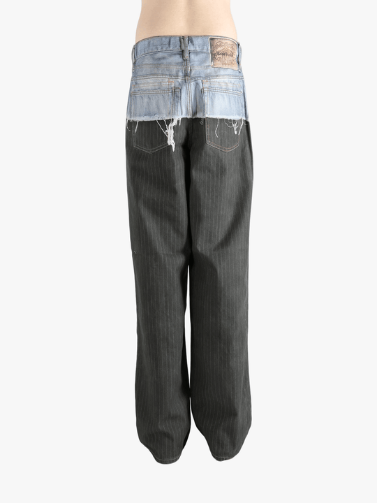 Black jeans worn by a person, showing the jeans fit