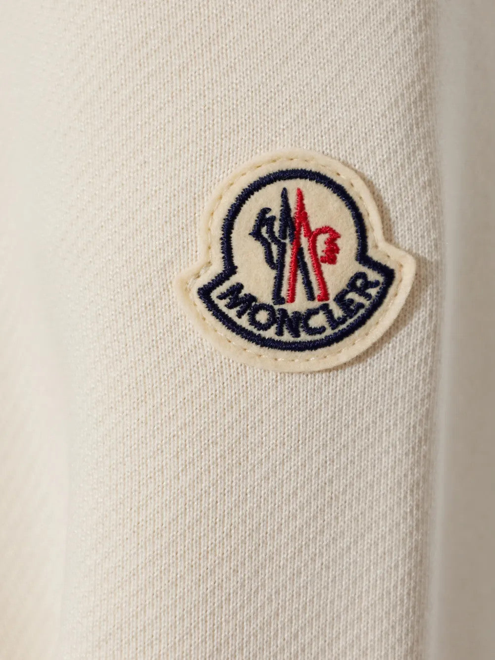 Close up of White knitwear, showing texture of the 100% polyamide fabric