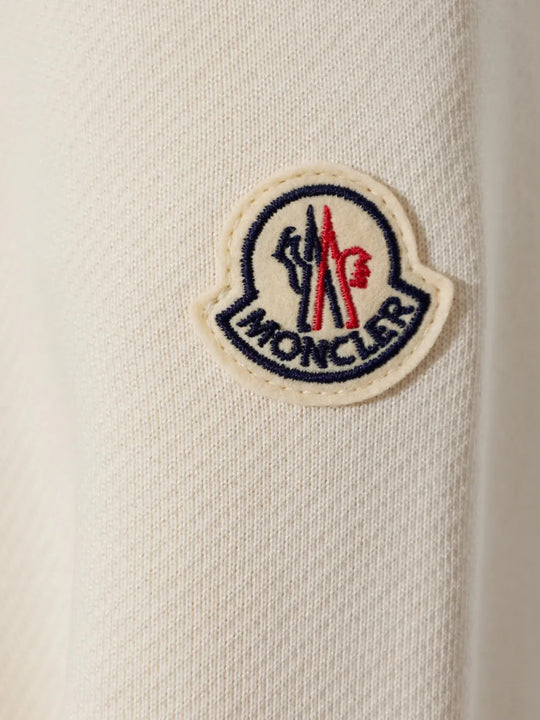 Close up of White knitwear, showing texture of the 100% polyamide fabric