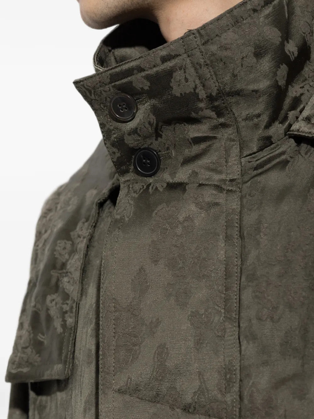 Green jacket worn by a person, showing the jacket fit