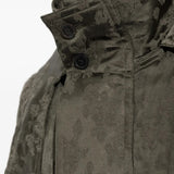 Green jacket worn by a person, showing the jacket fit
