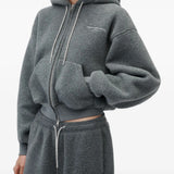 Grey hoodie worn by a person, showing the hoodie fit