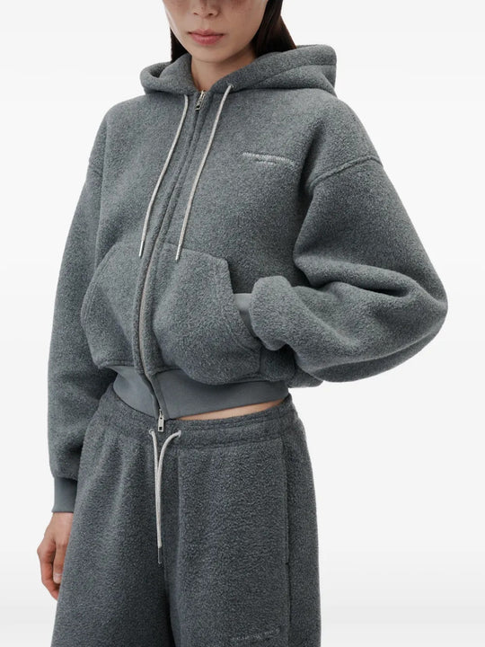 Grey hoodie worn by a person, showing the hoodie fit