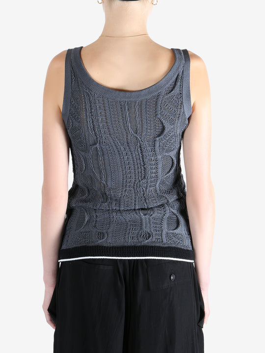 Blue tops worn by a person, showing the tops fit