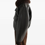 Black jacket worn by a person, showing the jacket fit