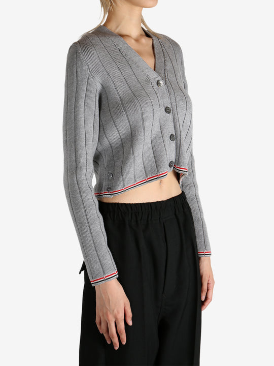 Grey knitwear worn by a person, showing the knitwear's fit