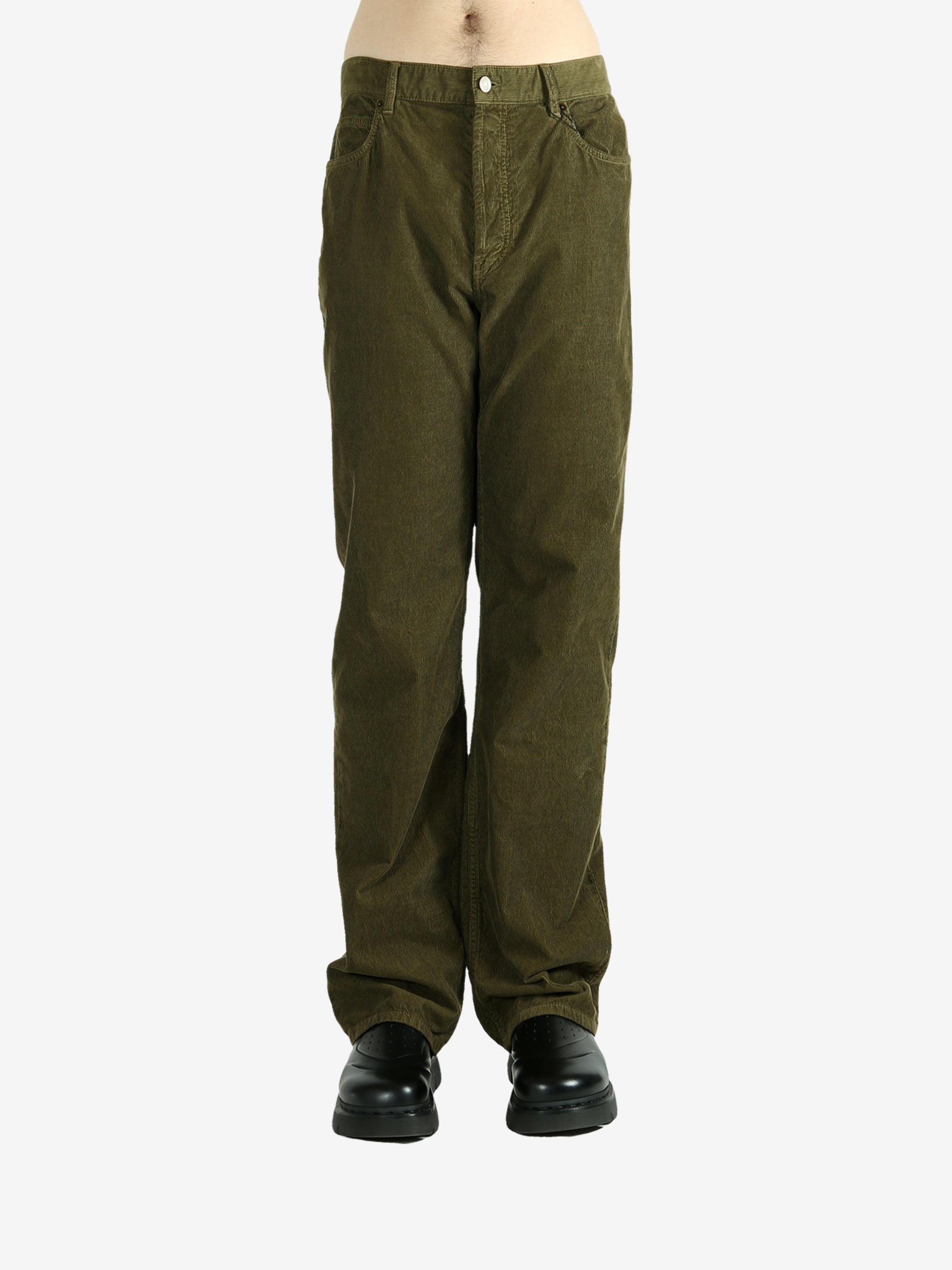 Green pants worn by a person, showing the pants's fit