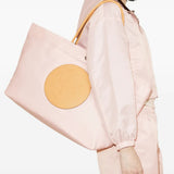 Pink bags worn by a person, showing the bags' fit 