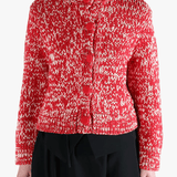 Red knitwear worn by a person, showing the knitwear fit