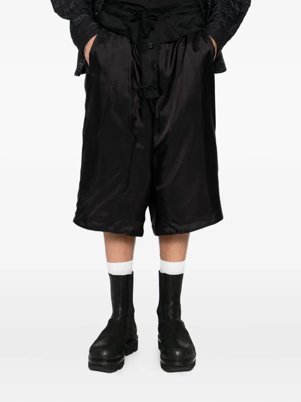 Black pants worn by a person, showing the pants fit