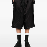 Black pants worn by a person, showing the pants fit