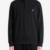 Black knitwear worn by a person, showing the knitwear fit