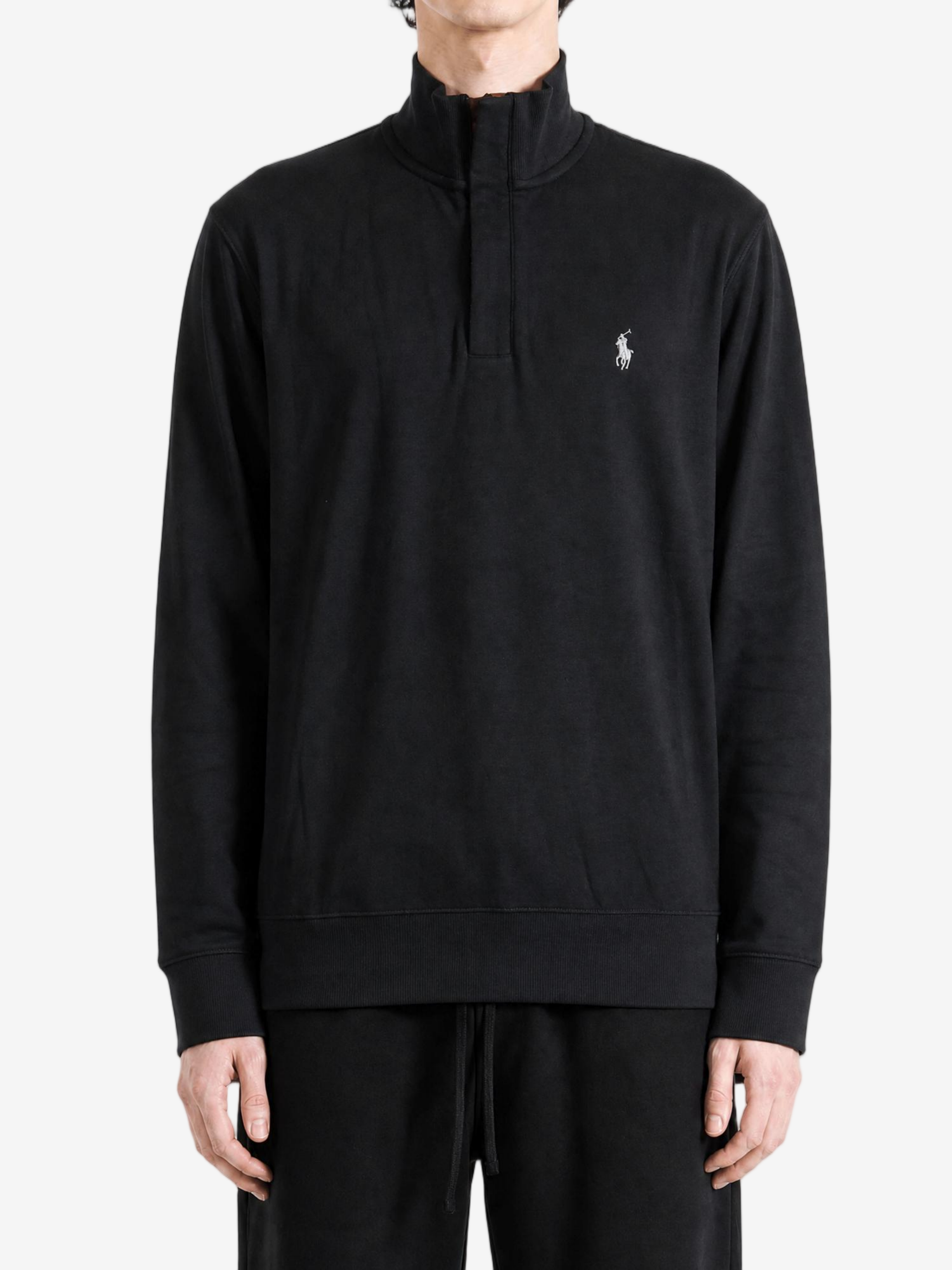 Black knitwear worn by a person, showing the knitwear fit