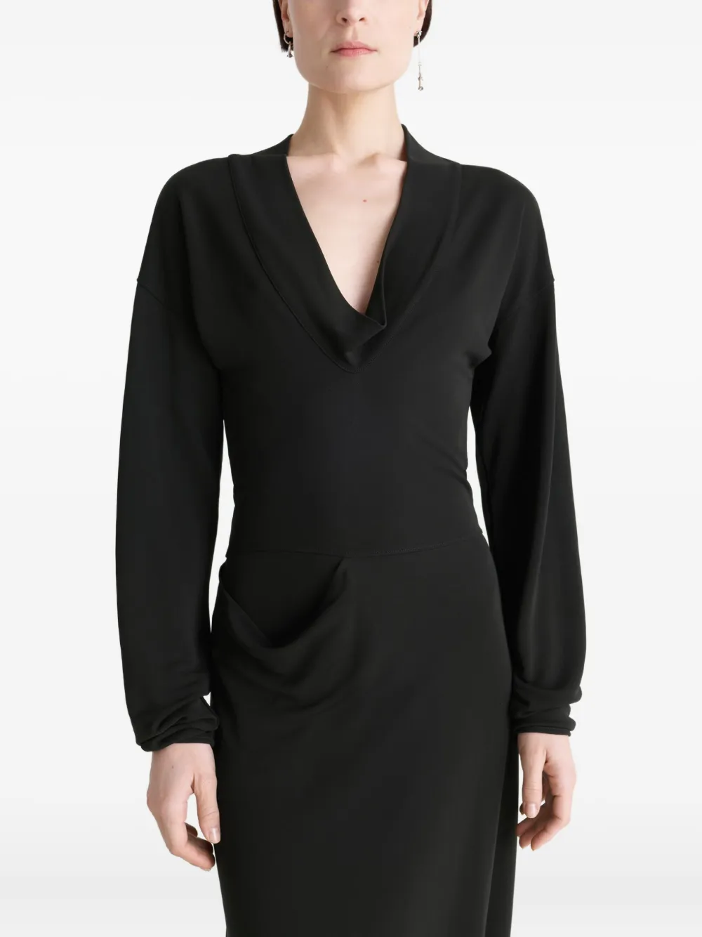 Black dress worn by a person, showing the dress fit