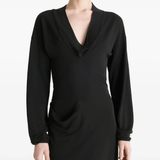 Black dress worn by a person, showing the dress fit