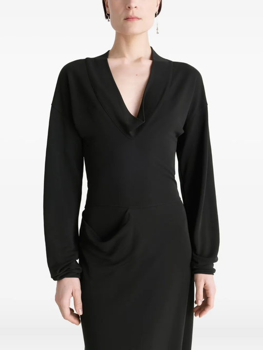 Black dress worn by a person, showing the dress fit