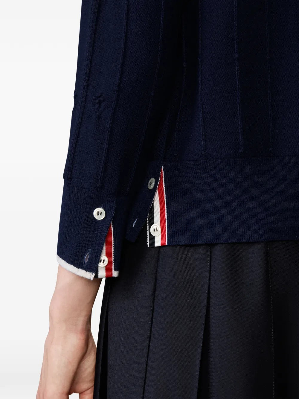 Close up of the navy knitwear, showing texture of the wool fabric