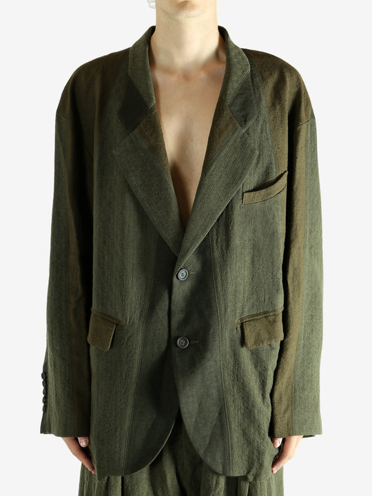 Green blazer worn by a person, showing the blazer's fit