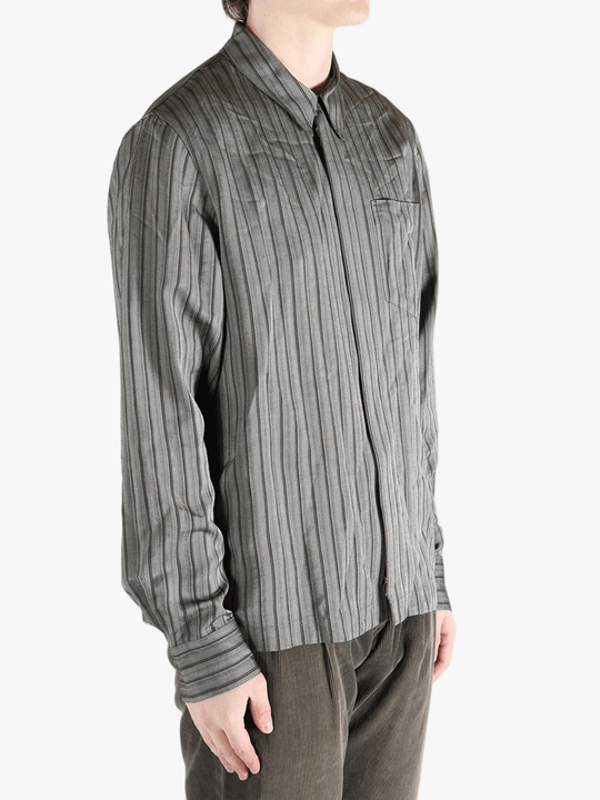 Grey shirt worn by a person, showing the shirt's fit
