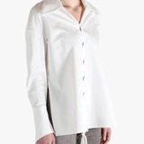 White shirt worn by a person, showing the shirt's fit