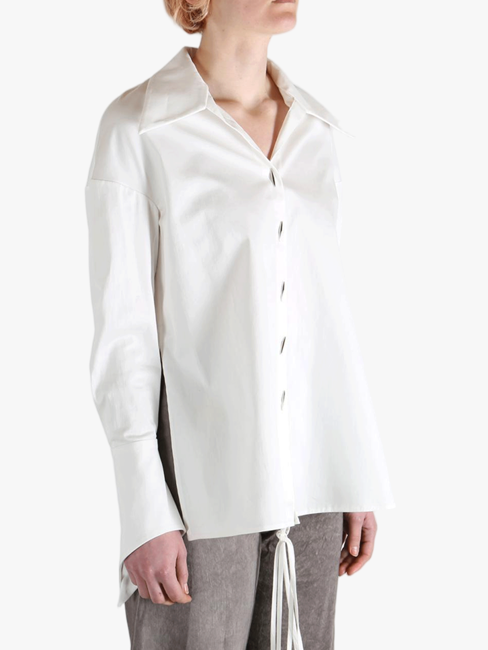 White shirt worn by a person, showing the shirt's fit