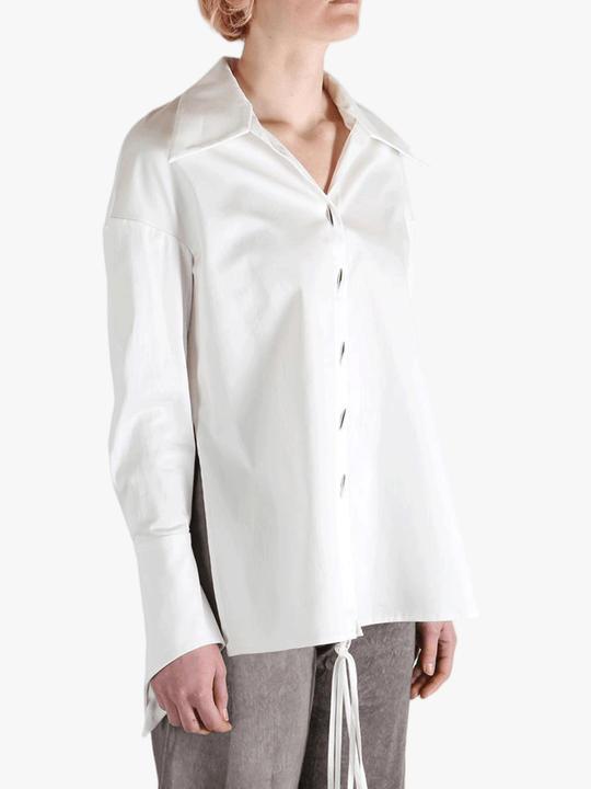 White shirt worn by a person, showing the shirt's fit