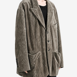 Grey blazer worn by a person, showing the blazer fit