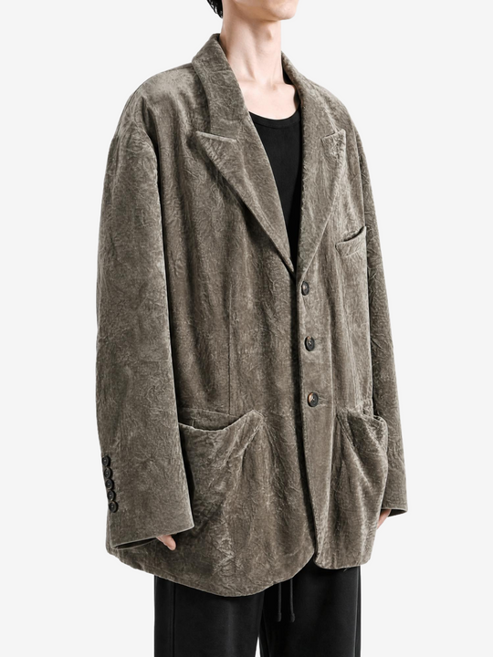 Grey blazer worn by a person, showing the blazer fit