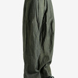 Green pants worn by a person, showing the pants' fit