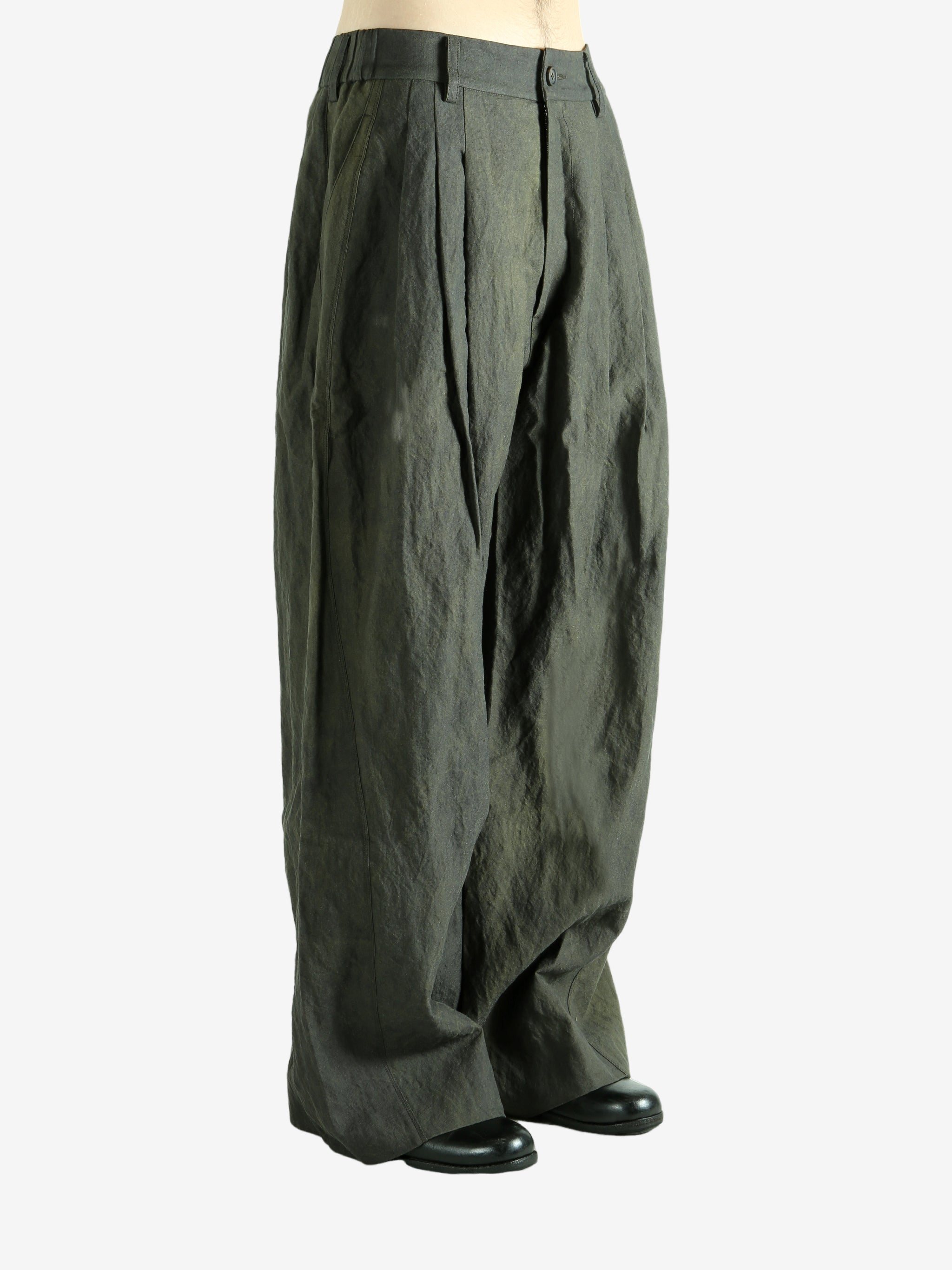 Green pants worn by a person, showing the pants' fit