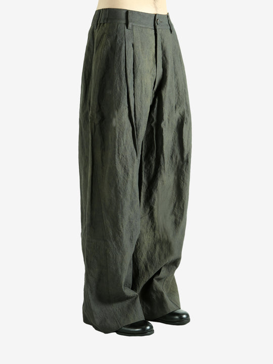 Green pants worn by a person, showing the pants' fit